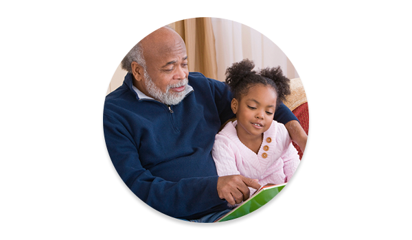 Grandfather & granddaugher reading.