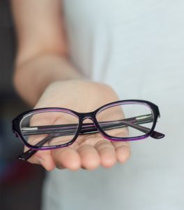 woman hold glasses in hands close up.